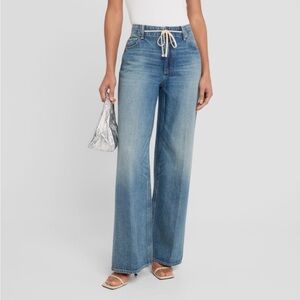 PAIGE "Zoey" jeans featuring a tie waist in faded medium-wash denim